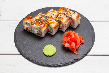 roll with eel on a black slate