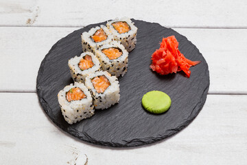 roll with salmon on a black slate