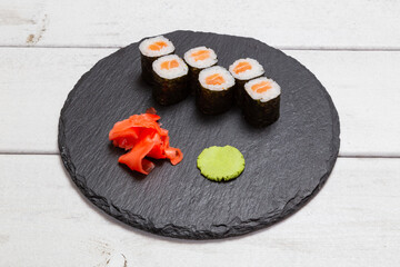 maki roll with salmon on a black slate