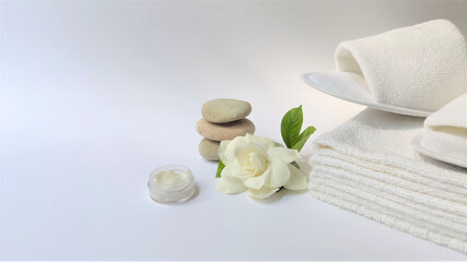 Spa setting and Spa background composition with white gardenia flower on white background. Banner