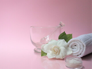 Spa setting and Spa background composition with white gardenia flower on pink background.