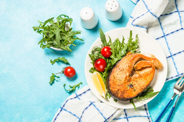 Salmon fish with fresh salad.