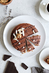 Homemade chocolate raw vegan cake - healthy dessert made from coconut milk, butter, cashew, cacao, walnut
