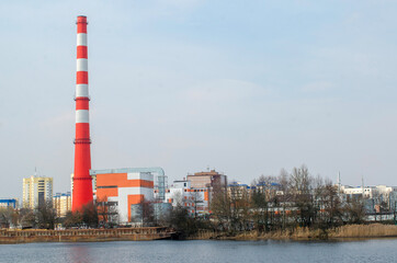 Obraz premium Factory pipe for the release of toxic waste on the shore of a reservoir.