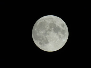 Genova, Italy - 07/05/2020: An amazing photography of the full moon over the city of Genova by...