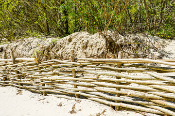 Fototapeta premium Wicker fences on the beach for the detention of sand movement and the reduction of man made effects