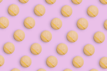 Macaroons pattern on colored background, a pattern of colorful french cookies macarons. Beige french cookies macarons on purple background. Gift for congratulations.
