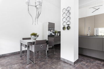 Elegant kitchen with dining room table and grey design in fashionable house