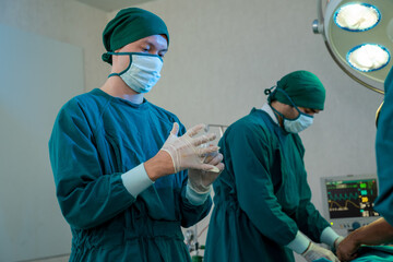 Fototapeta na wymiar Surgery team in the operating room,Ready to work on a patient,Medical worker in surgical uniform in the operating room in a hospital.