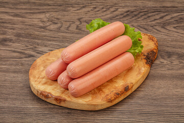 Tasty meat sausages over board