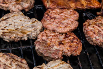 fresh burger patties on the grill