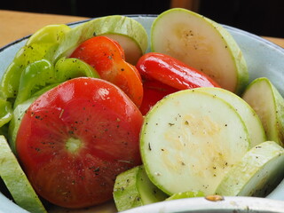 zucchini with tomatoes sliced marinated with spices for frying