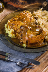 Fried ribs in sauerkraut served with boiled potatoes.