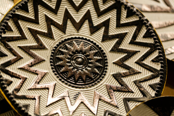 Vintage ceramic with carved ornament. Old Greek patterned pottery close-up, the background selective focus and shallow depth of field.