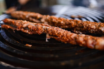 Minced meat kebab is baked. Barbecue and outdoor party