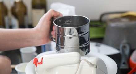Girl at home cooking and baking a cake