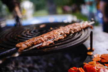 Minced meat kebab is baked. Barbecue and outdoor party