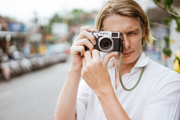 portrait of a man photographer with camera while on summer holiday