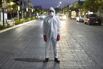 Conceptual portrait of a person standing in the street wearing protective clothing