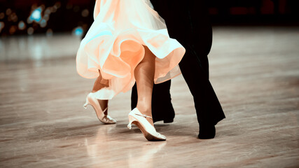Man and woman dancer latino international dancing.  Ballroom dancing is a team sport. Vintage color filter..