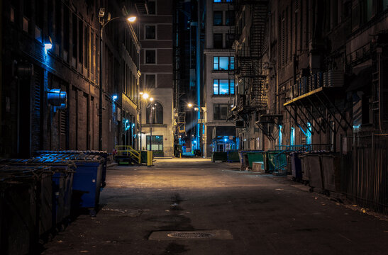 Illuminated Street Amidst Buildings At Night