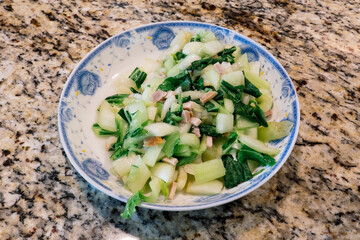 Bok Choy and pork in a white plate