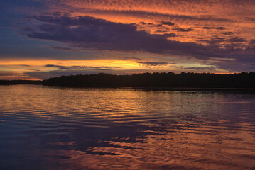 Fototapeta premium summer sunset over lake with reflection in water