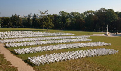 Lots of empty plastic chairs on grass square in front of sanctuary called Jasna Góra in Częstochowa, Poland © Wioletta