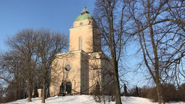 Helsinki, Finland, A clock tower covered in snow with Bruton Parish Church in the background