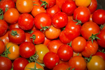 Red cherry tomatoes background. Fresh bright organic vegetables. A lot of Small Cherry tomatoes.