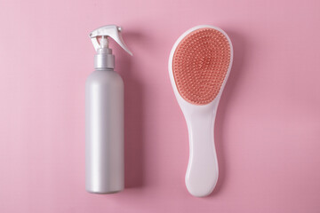 different hairdresser's items or haircare objects on pink background. minimalism style.
