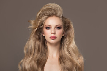 Portrait of a blonde girl with long beautiful wavy hair