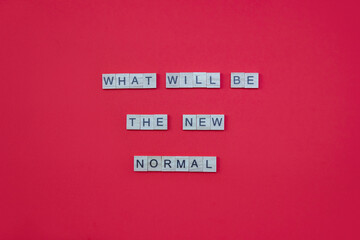 Obraz premium Words What Will Be The New Normal. Wooden blocks with lettering on red background. Top view, layout