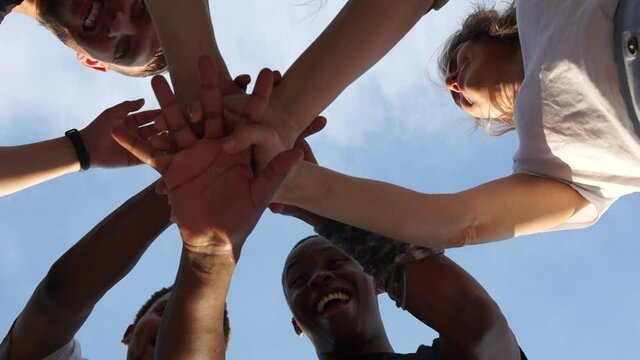 Crossed hands of people of different colors, multi-racial group of people, support and solidarity of the BLM movement against racism, black lives matter. Interrasial group of students