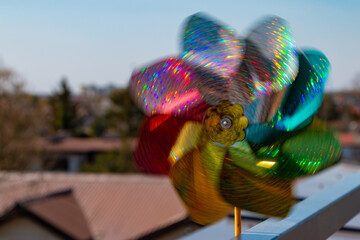 Spinning multicolor pinwheel reflecting sun
