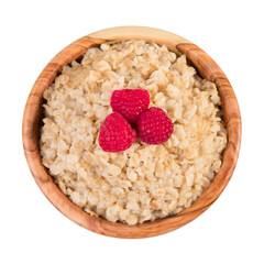 Oatmeal with raspberry berries in a wooden bowl isolated on a white background.