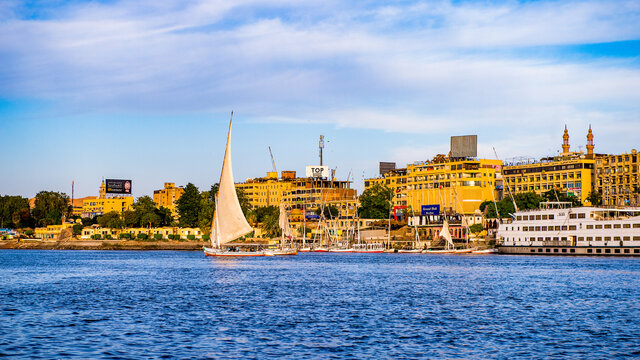 ASWAN, EGYPT - DEC 2, 2014: Felluca on the Nile in Aswan city in Egypt. Aswan is a busy market and tourist centre and the capital of the Aswan Governorate.