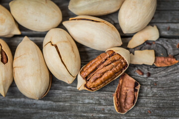 Pecan nuts (Carya illinoinensis) as background texture closeup, top view