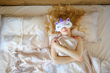 Woman in pajamas having a bad sleep with eye mask