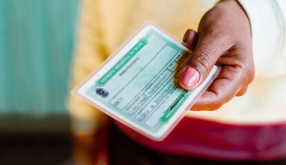 Woman holds the Voter License (Título Eleitoral). It is a document that proves that the person is...