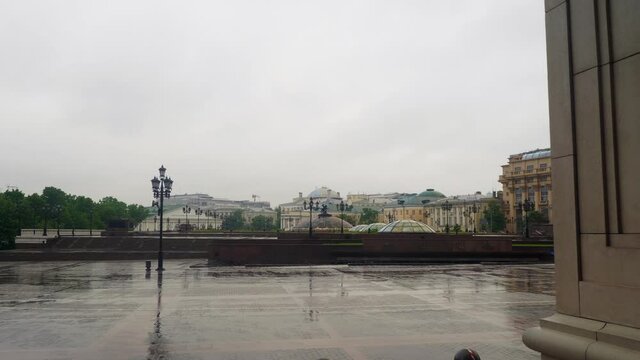 Wet Red square pavement without tourists in rainy afternoon. Pandemic