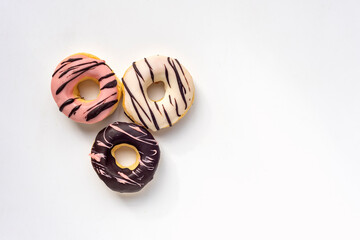 Obraz na płótnie Canvas colored glazed donuts on white background