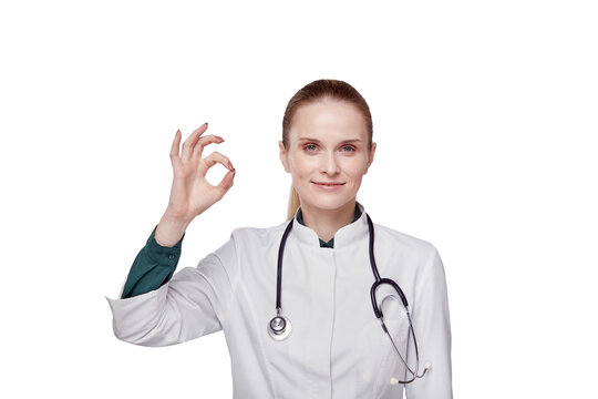 Beautiful woman doctor in a medical coat shows a gesture everything is super, ok