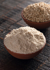 Bowl of Sprouted Sorghum and Sorghum Flour on a Dark Wooden Table