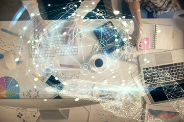 Double exposure of man and woman working together and social network theme hologram drawing. Computer background. connecting concept. Top View.