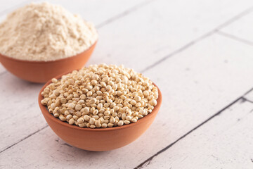 Bowl of Sprouted Sorghum and Sorghum Flour on a Bright White Table