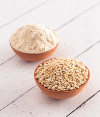 Bowl of Sprouted Sorghum and Sorghum Flour on a Bright White Table