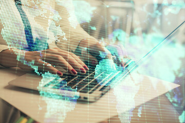 Multi exposure of woman hands typing on computer and business theme hologram drawing. Success...