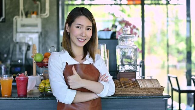 Startup new business Portrait of Asian female barista coffee shop owner at cafe