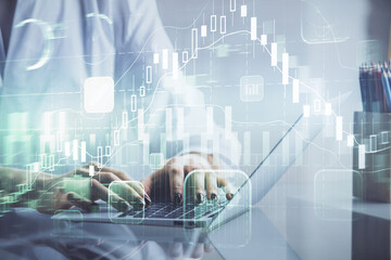 Double exposure of woman hands typing on computer and forex chart hologram drawing. Stock market...